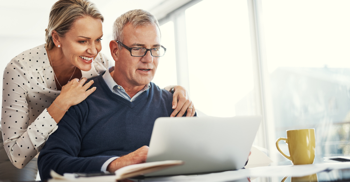 A couple looking at a computer screen together.