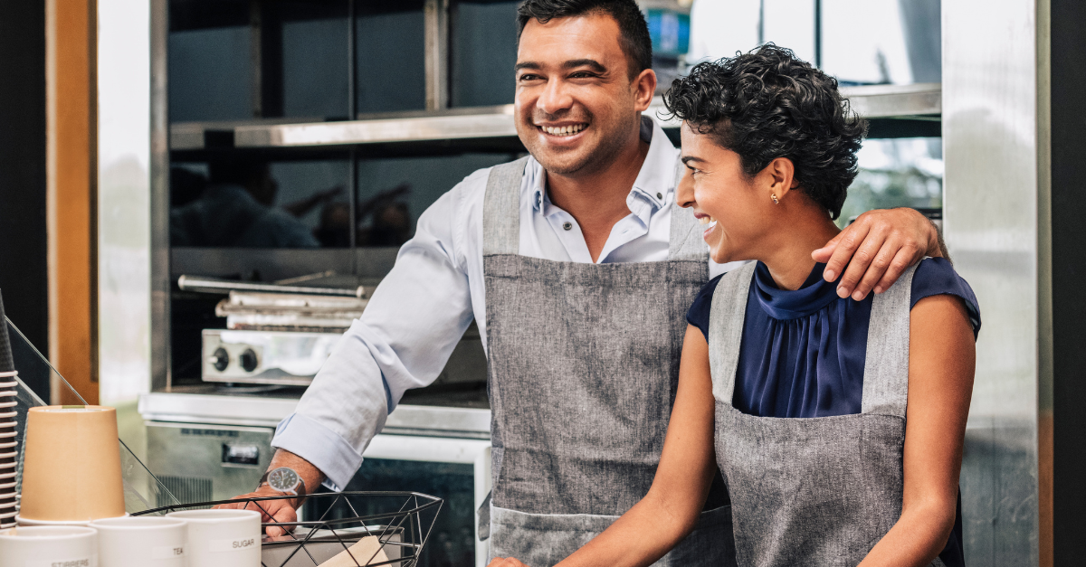 A man and his daughter smiling in their family business