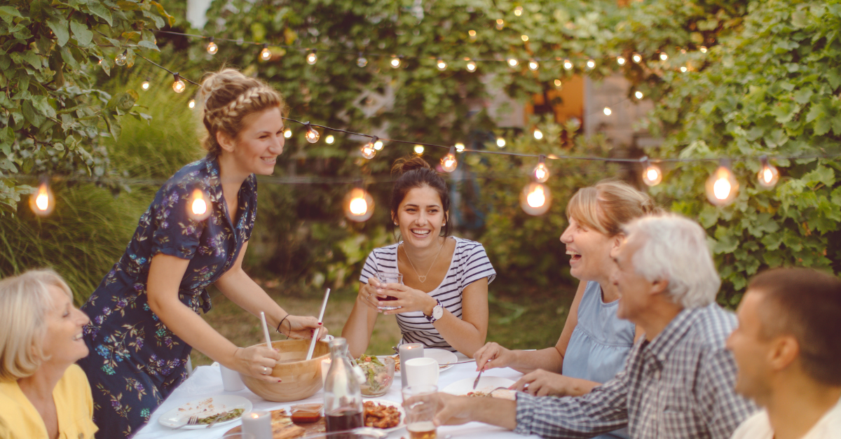 A multi-generational family enjoying a meal outdoors
